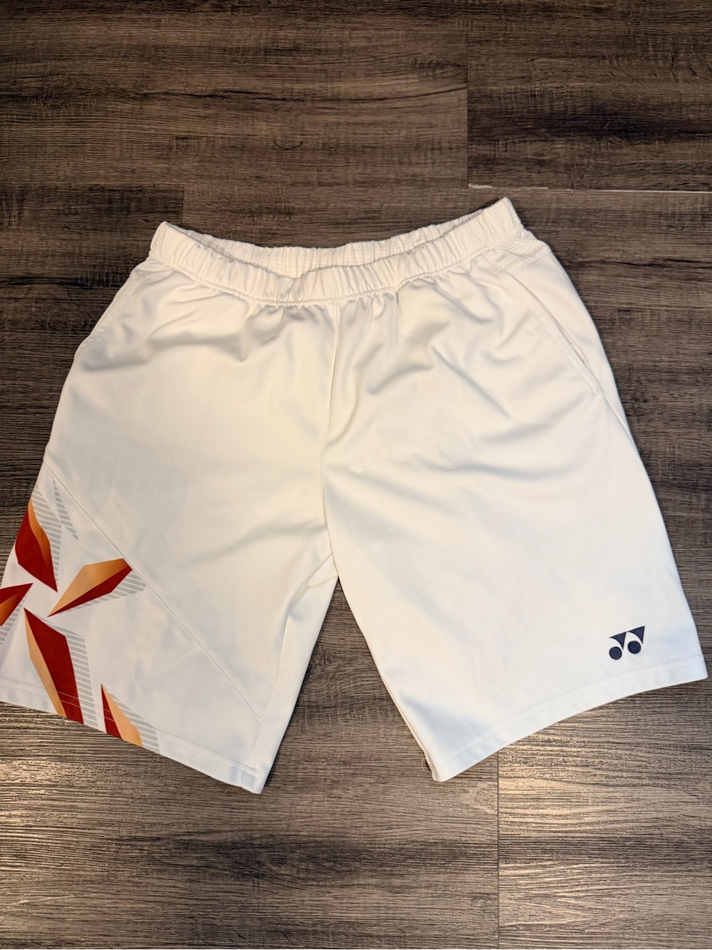 Yonex White Men’s Athletic Shorts with Orange Accent